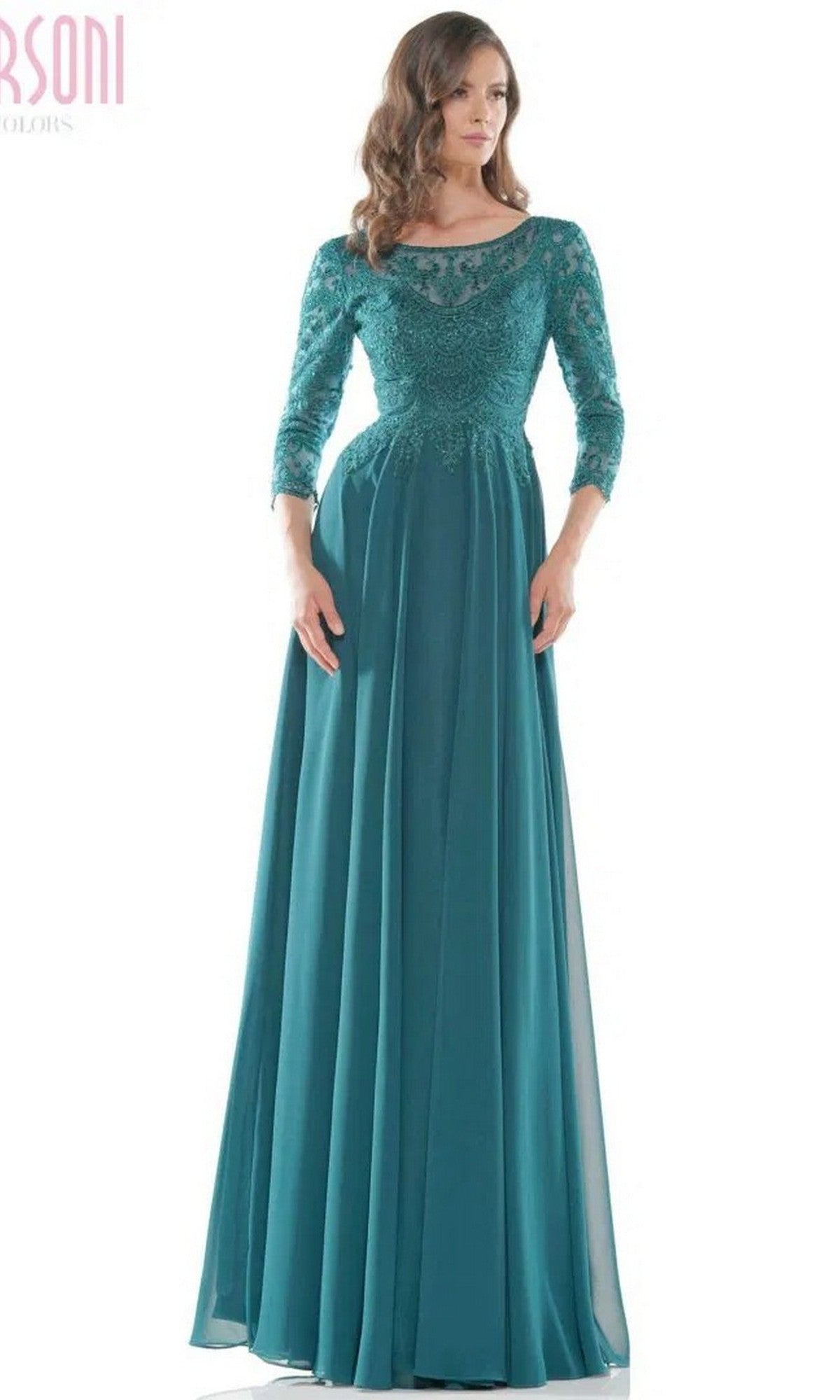 A woman models the Marsoni M238SL long formal dress in teal, featuring lace details, a beaded bodice, elegant sleeves, and a chiffon A-line skirt, standing against a plain white background.